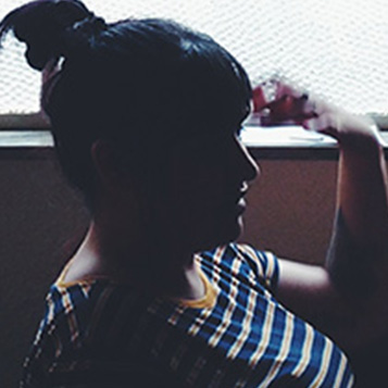 Woman sitting in the shadow in profile