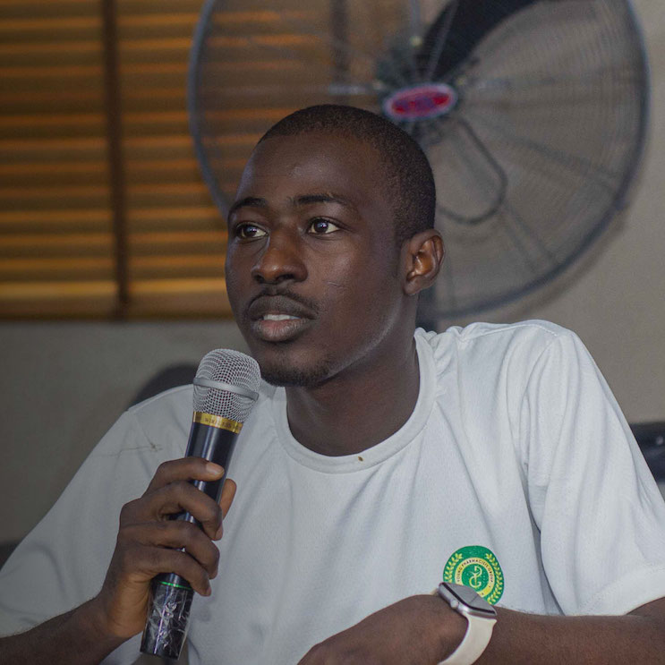 Portrait of Yusuf Hassan Wada with a microphone