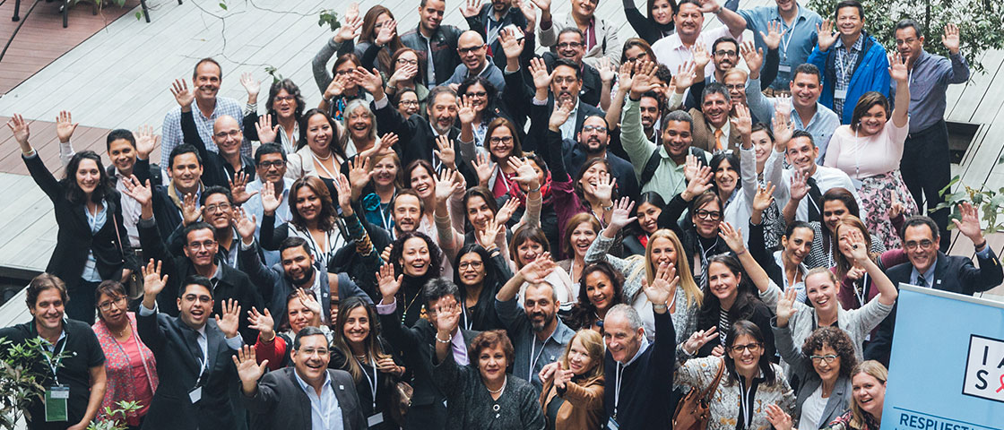 Overhead view of a crowd of happy people in business attire looking up and waving