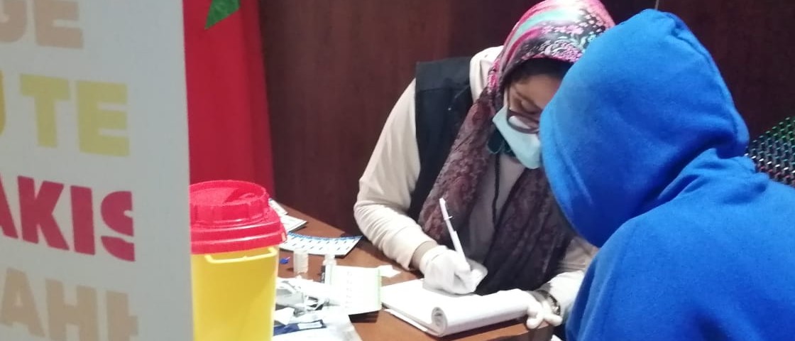 Two people sitting at a desk in a clinic