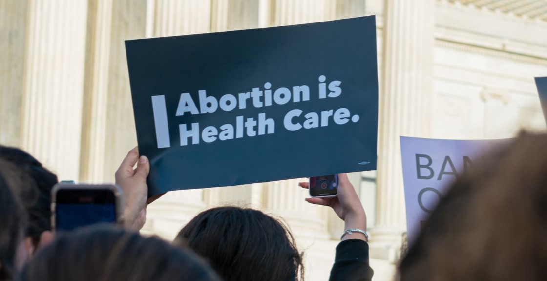 Woman holding abortion banner