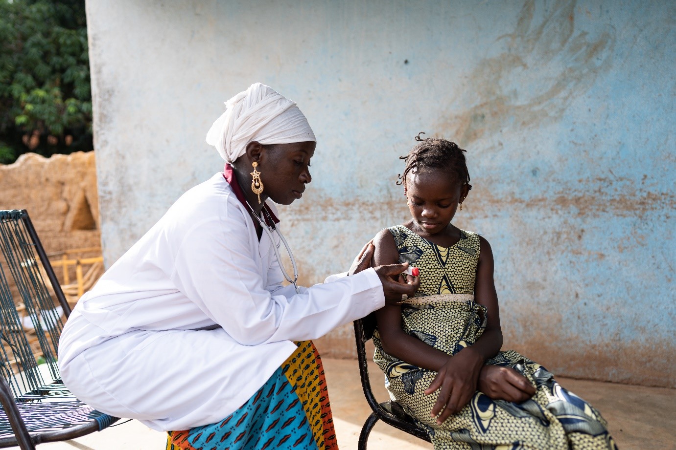 An African doctor treating a young child